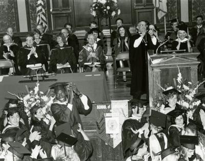 Mutombo celebrates his graduation with classmates as professors watch