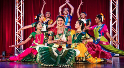 Rangila dancers in traditional clothing posing on stage