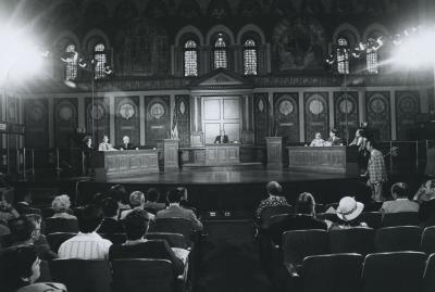 Six students and one moderator on Gaston Hall's stage for a debate