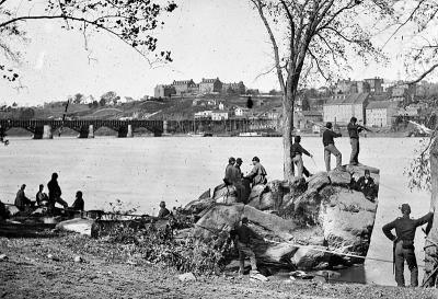 Union troops on Roosevelt Island, sometime after the Battle of Gettysburg in July 1863. The Georgetown campus can be seen, top left, on the hilltop.