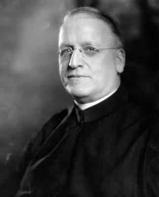 Black and white photo of Charles W. Lyons, S.J., President of Georgetown, wearing clerical robes