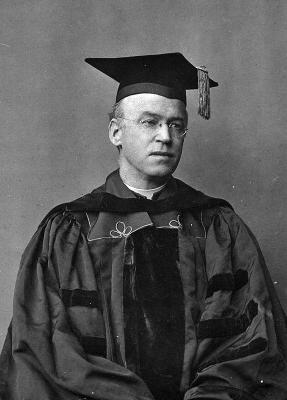 Black and white photo of Fr. John B. Creeden in 1920 wearing full academic regalia with mortarboard and tassel. 