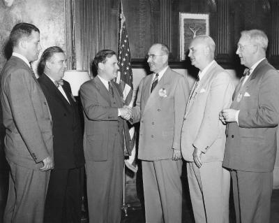 Thomas A. Dean (C'1920) turns the presidency of the Georgetown University Alumni Association over to Thomas C. Mee (C'1917), 1948