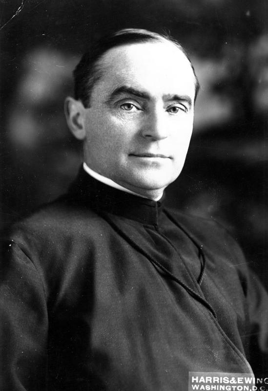 Black and white headshot of Fr. Alphonsus Donlon wearing clerical robes. 