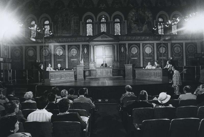 Six students and one moderator on Gaston Hall's stage for a debate